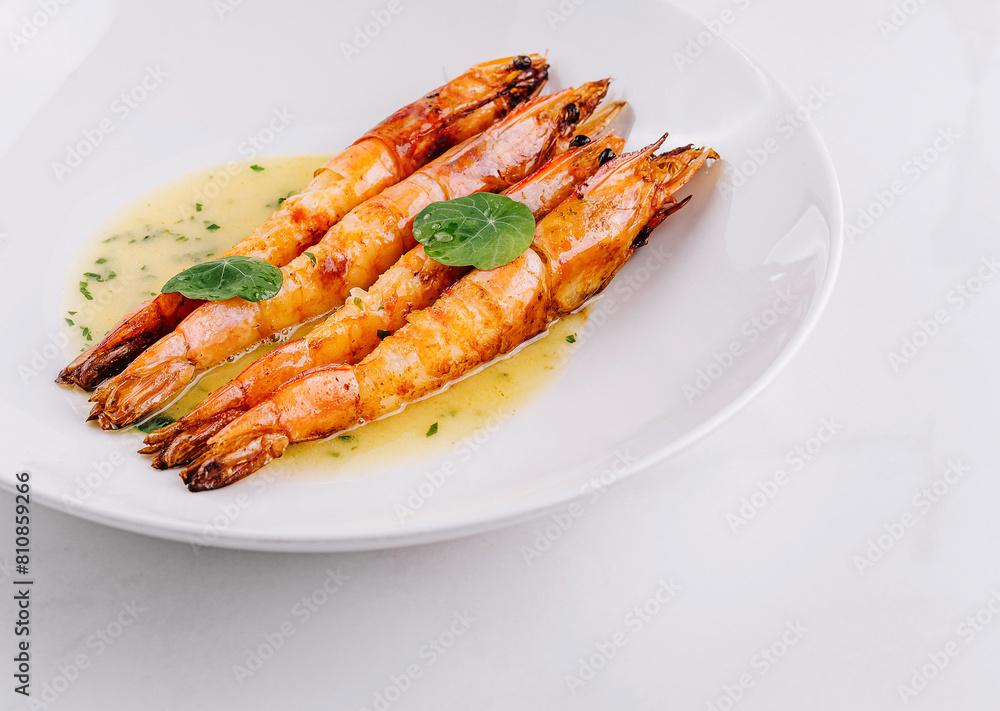 Grilled shrimp with garlic sauce on white plate Grilled shrimp with garlic sauce on white plate