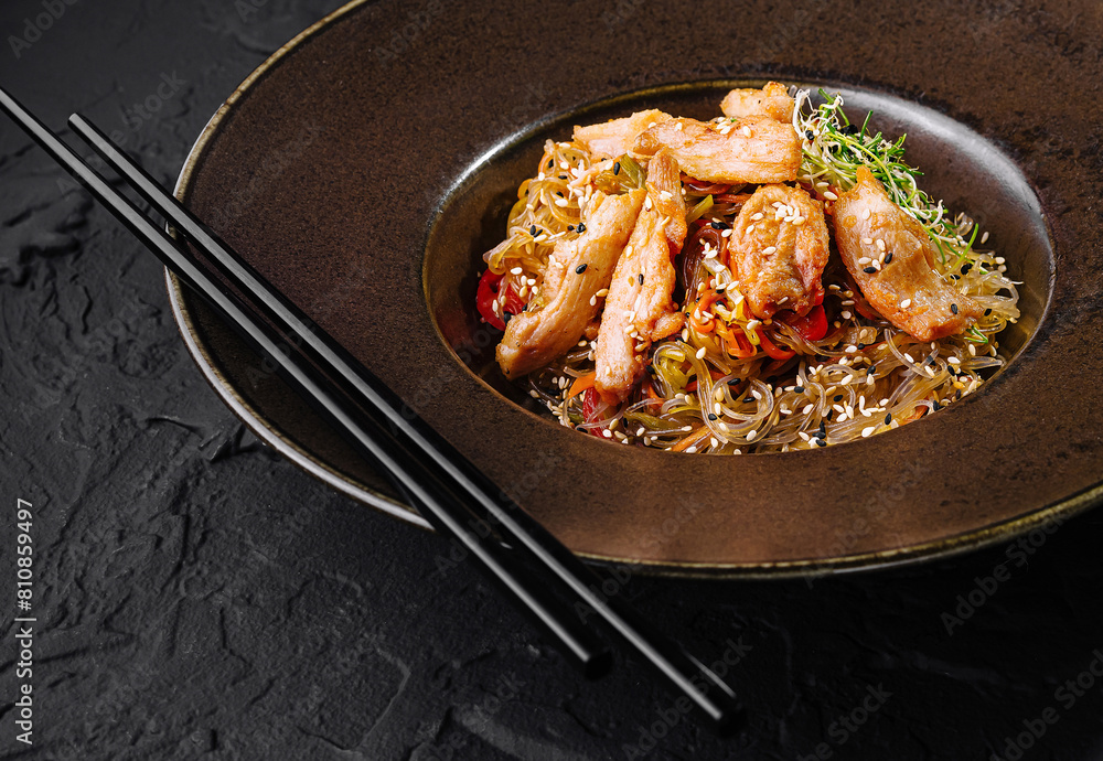 Gourmet asian noodle dish on elegant dark table Gourmet asian noodle dish on elegant dark table