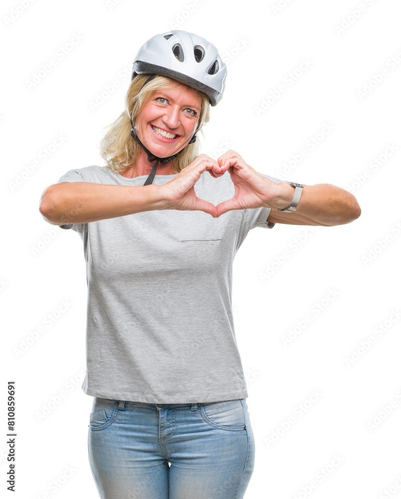 Middle age caucasian cyclist woman wearing safety helmet over isolated background smiling in love showing heart symbol and shape with hands. Romantic concept. Middle age caucasian cyclist woman wearing safety helmet over isolated background smiling in love showing heart symbol and shape with hands. Romantic concept.