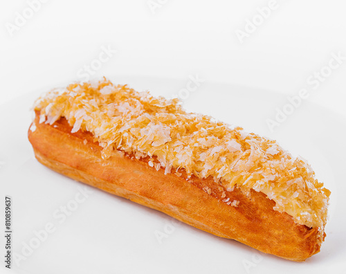 Fresh coconut eclair on white plate