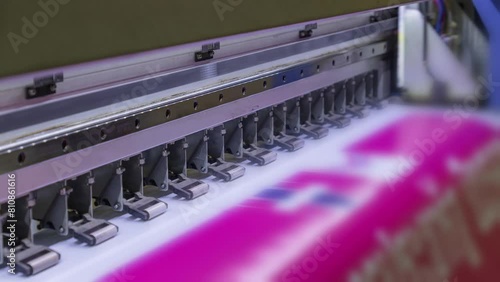 Large format inkjet printer printing with pink color on vinyl paper