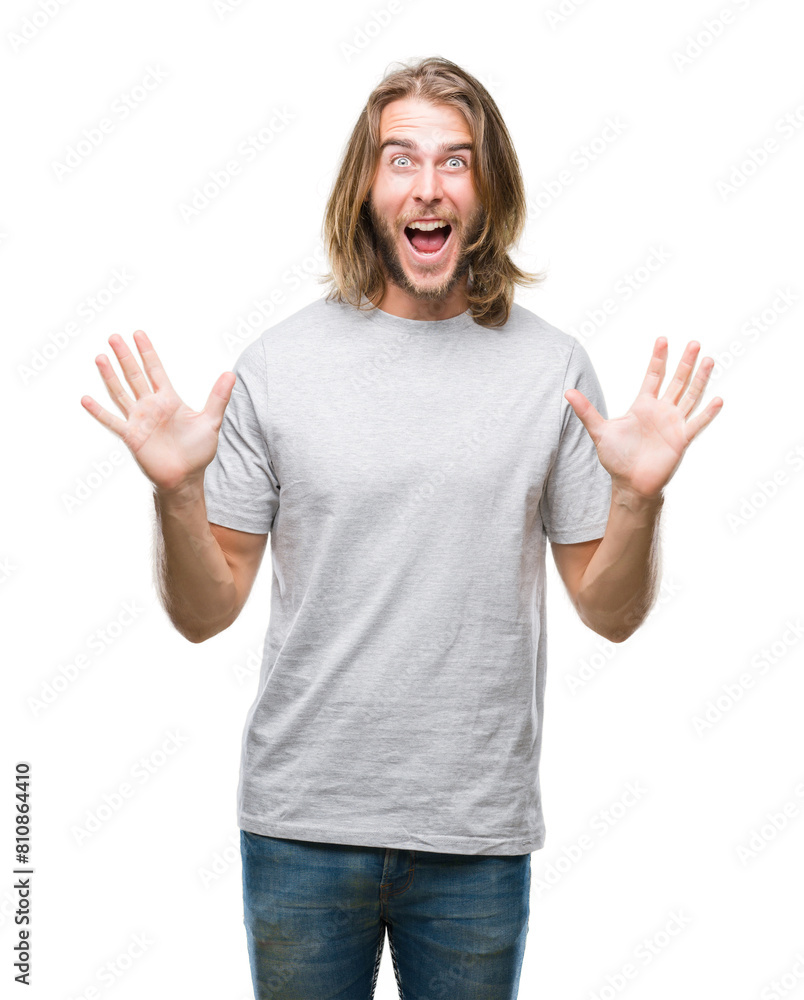 Young handsome man with long hair over isolated background celebrating crazy and amazed for success with arms raised and open eyes screaming excited. Winner concept Young handsome man with long hair over isolated background celebrating crazy and amazed for success with arms raised and open eyes screaming excited. Winner concept