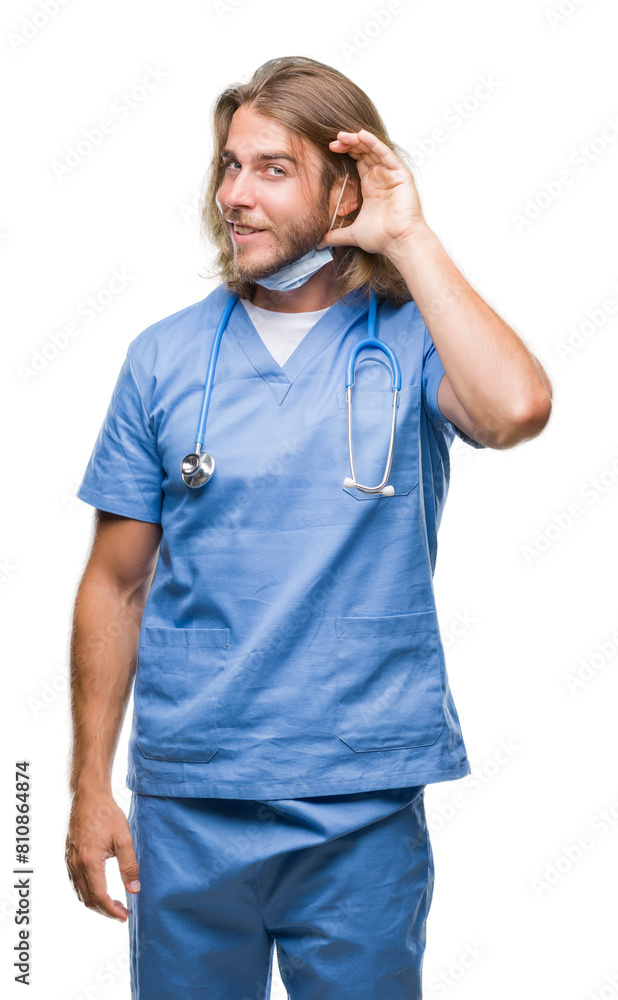 Young handsome doctor man with long hair over isolated background smiling with hand over ear listening an hearing to rumor or gossip. Deafness concept. Young handsome doctor man with long hair over isolated background smiling with hand over ear listening an hearing to rumor or gossip. Deafness concept.