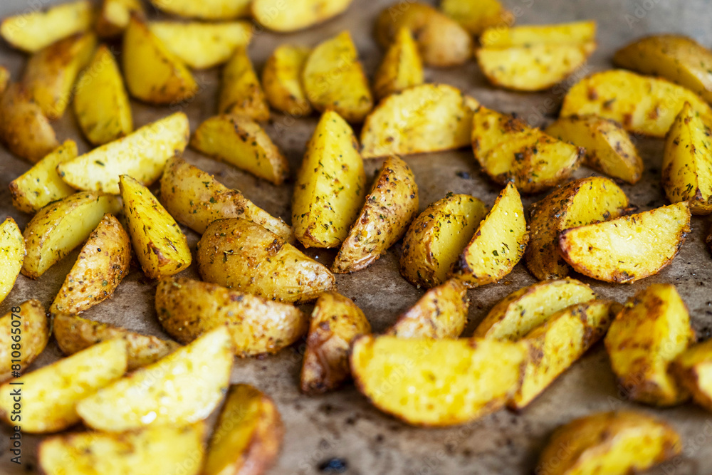 Appetizing baked potato slices with spices, close up Appetizing baked potato slices with spices, close up