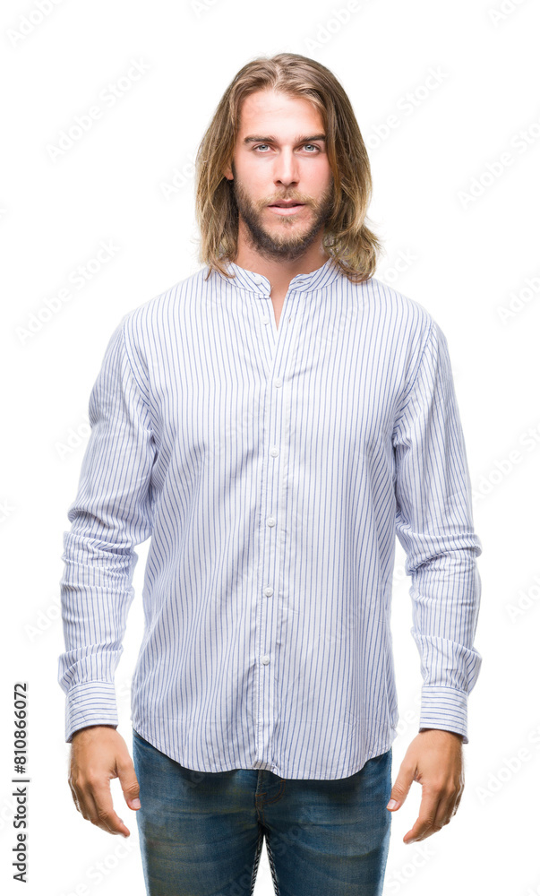 Young handsome man with long hair over isolated background with serious expression on face. Simple and natural looking at the camera. Young handsome man with long hair over isolated background with serious expression on face. Simple and natural looking at the camera.