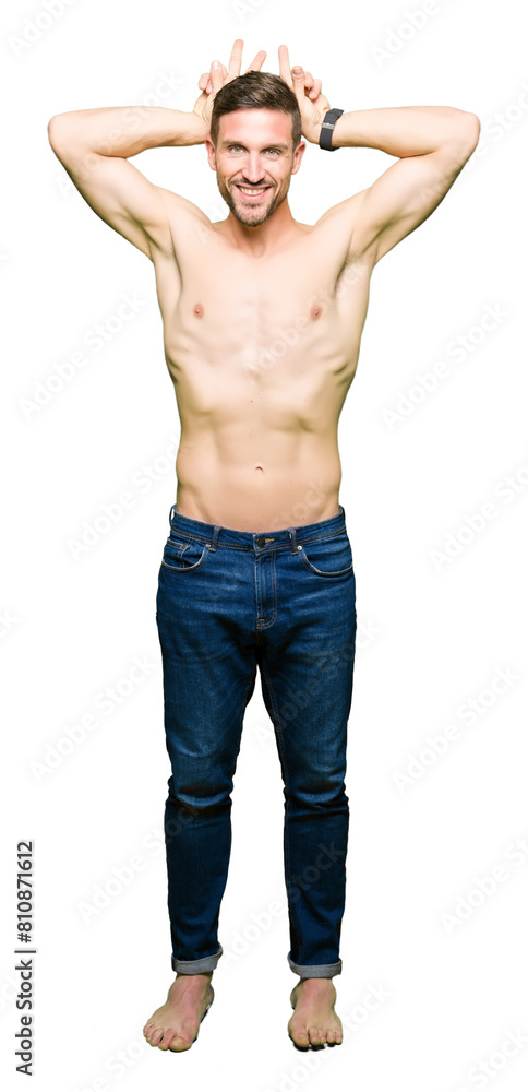 Handsome shirtless man showing nude chest Posing funny and crazy with fingers on head as bunny ears, smiling cheerful Handsome shirtless man showing nude chest Posing funny and crazy with fingers on head as bunny ears, smiling cheerful