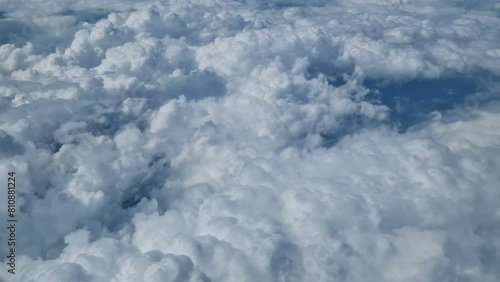 Aerial view of clouds, blue sunny sky, bird's-eye view.