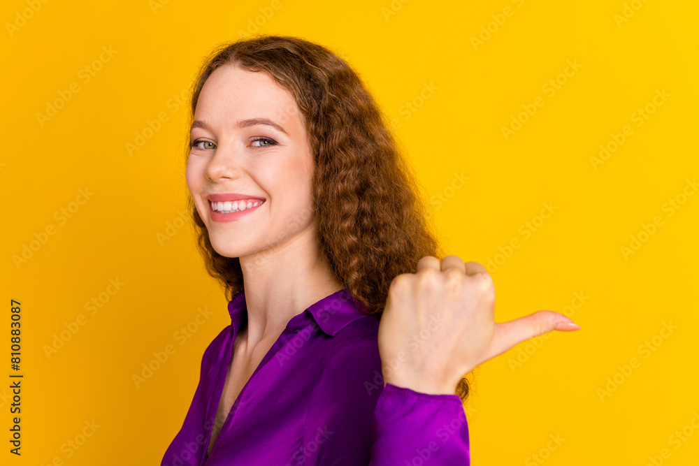 Photo portrait of pretty young girl point empty space wear trendy violet outfit isolated on yellow color background Photo portrait of pretty young girl point empty space wear trendy violet outfit isolated on yellow color background