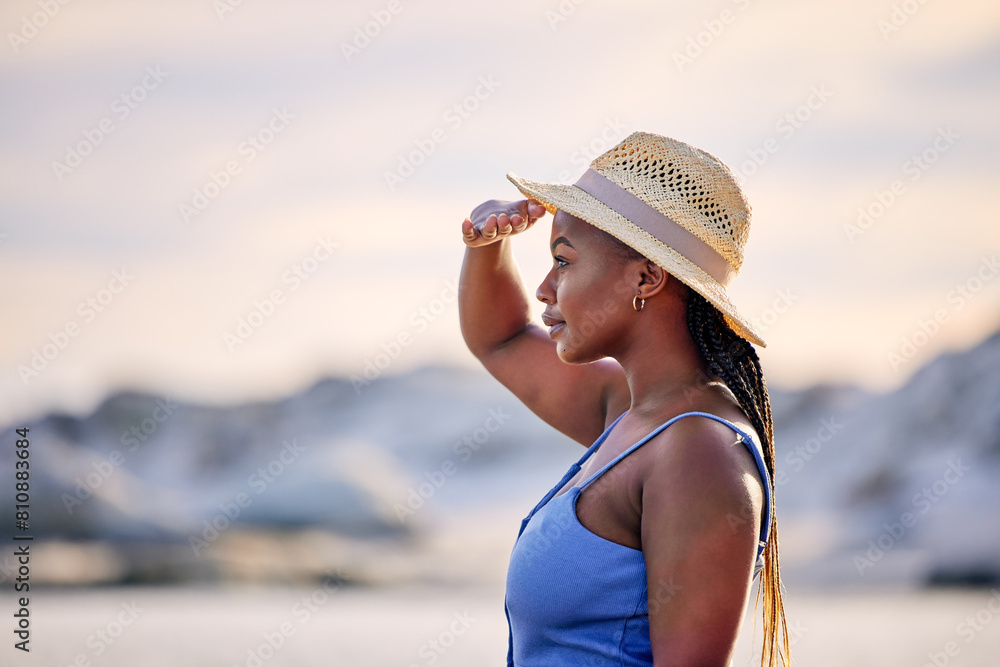 View, beach or black woman on holiday to relax on vacation for break in Greece at sunset in summer. Tourist, girl or African person looking to at ocean, nature or sea with peace, wellness or travel