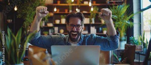 Work on laptop computer, celebrate success. Digital entrepreneur working with e-commerce app smiles, happy victory. Motion blur background. photo