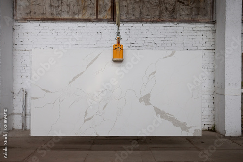Picture of a marble slab on a hanger, shot in natural light, a cut of decorative marble in a warehouse, a large piece of marble. High Resolution. Quartz Santa Margherita Mistral photo