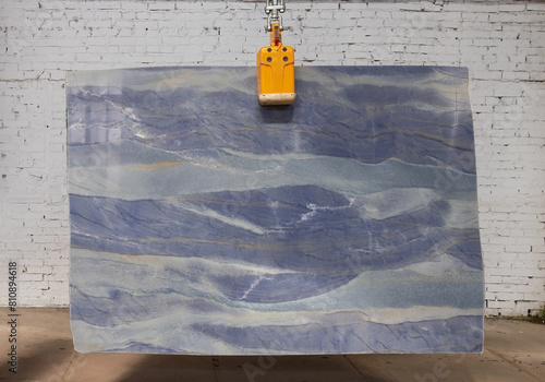 Picture of a marble slab on a hanger, shot in natural light, a cut of decorative marble in a warehouse, a large piece of marble. High Resolution. Quarzite Azul Boquira photo