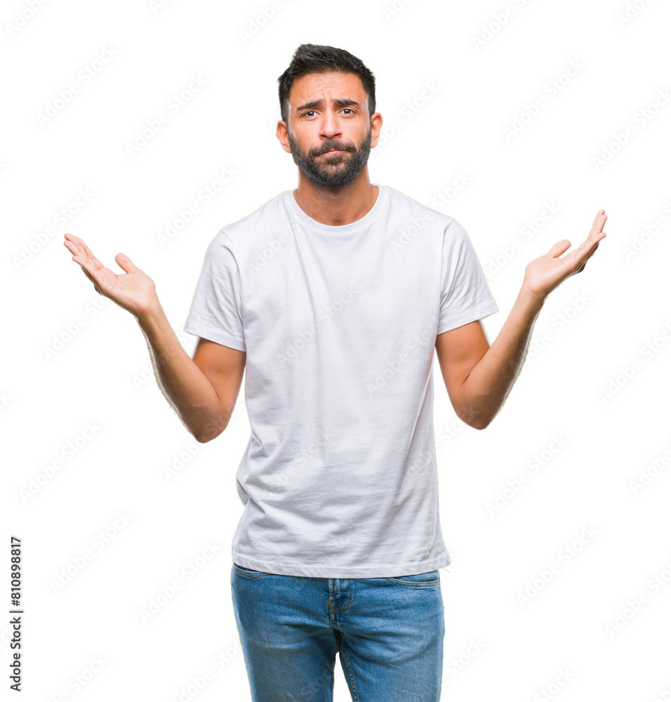 Adult hispanic man over isolated background clueless and confused expression with arms and hands raised. Doubt concept. Adult hispanic man over isolated background clueless and confused expression with arms and hands raised. Doubt concept.