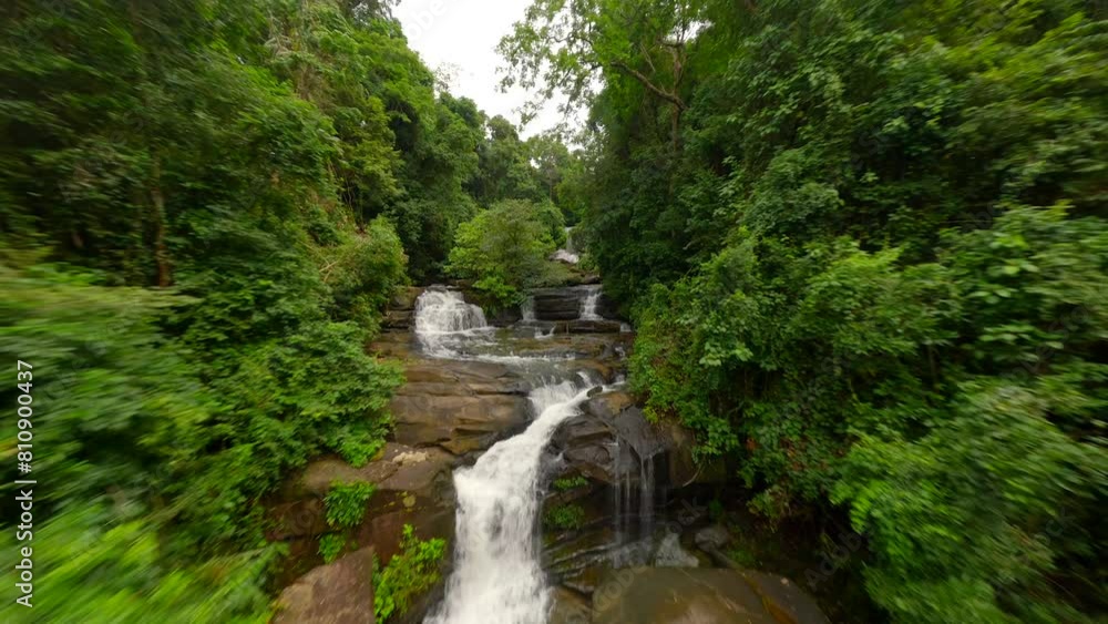 FPV flight over tropical river and waterfalls in the lush jungle in Thailand FPV flight over tropical river and waterfalls in the lush jungle in Thailand