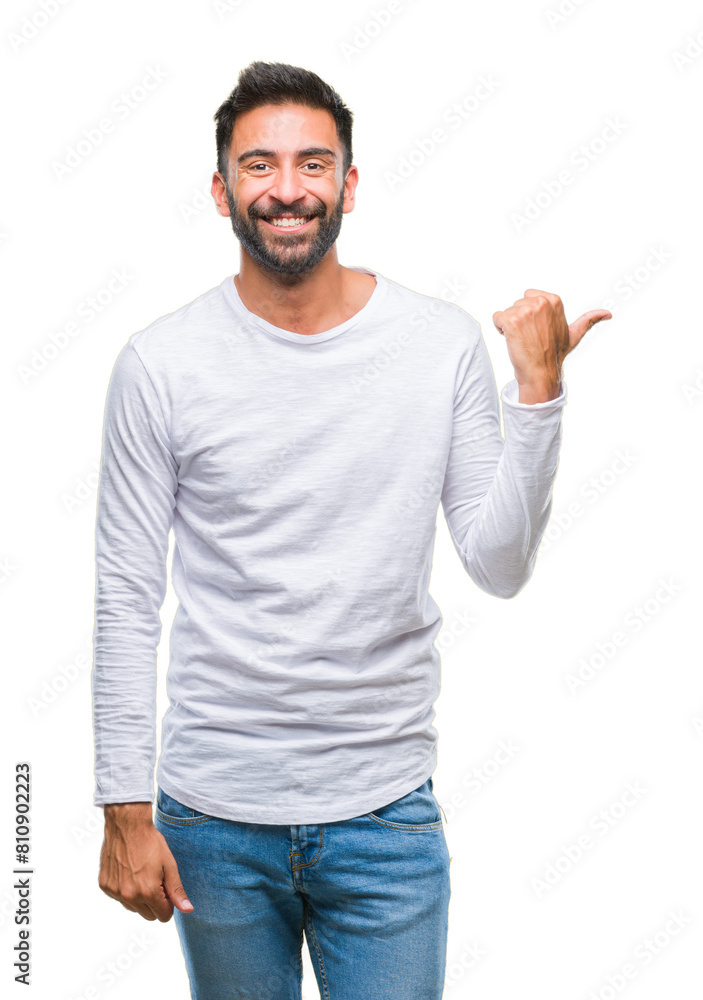 Adult hispanic man over isolated background smiling with happy face looking and pointing to the side with thumb up. Adult hispanic man over isolated background smiling with happy face looking and pointing to the side with thumb up.