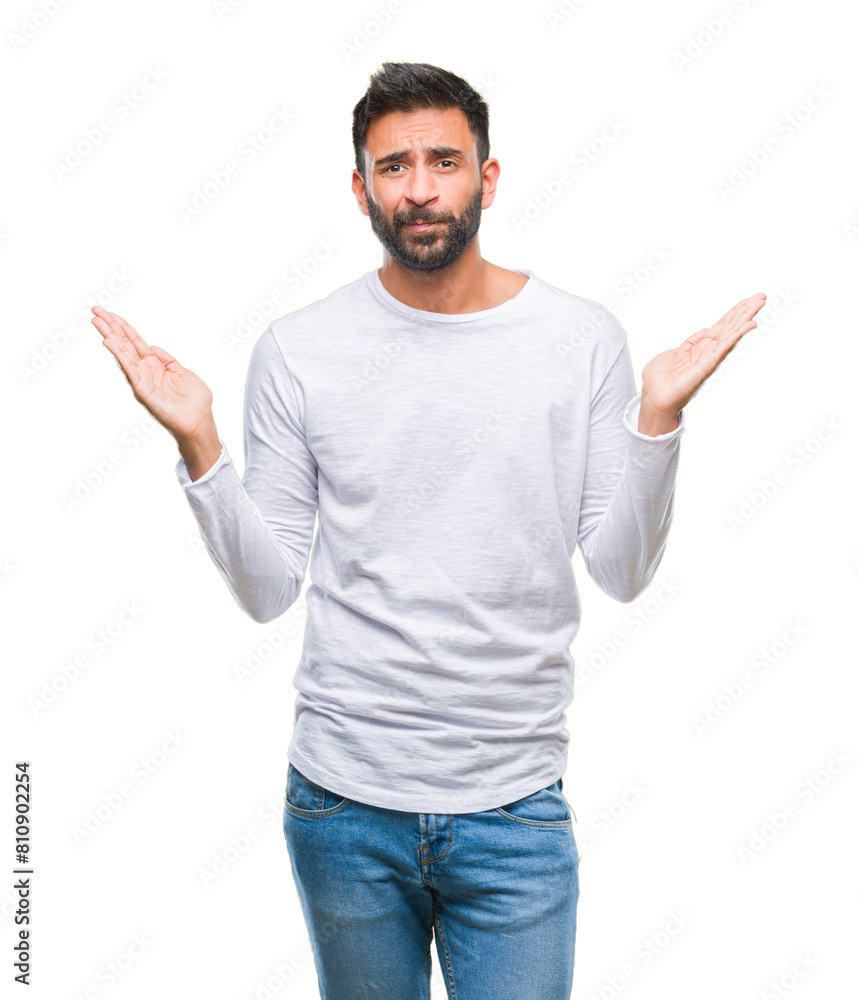 Adult hispanic man over isolated background clueless and confused expression with arms and hands raised. Doubt concept. Adult hispanic man over isolated background clueless and confused expression with arms and hands raised. Doubt concept.