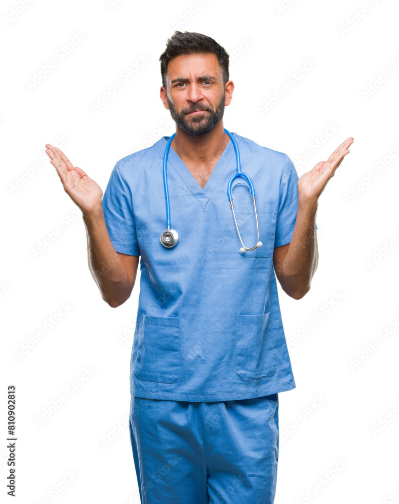 Adult hispanic doctor or surgeon man over isolated background clueless and confused expression with arms and hands raised. Doubt concept. Adult hispanic doctor or surgeon man over isolated background clueless and confused expression with arms and hands raised. Doubt concept.