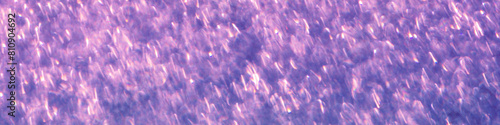 Blue-purple glitter abstract background of blurred shiny lights