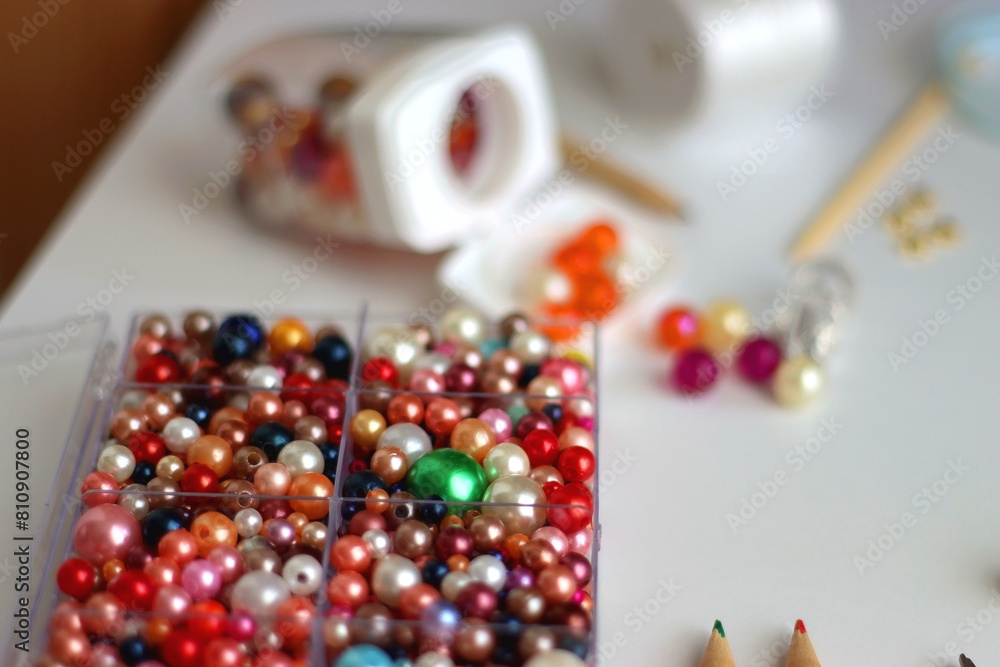 Various craft supplies on white background. Supplies for jewelry making, drawing and needlework. Selective focus. Various craft supplies on white background. Supplies for jewelry making, drawing and needlework. Selective focus.