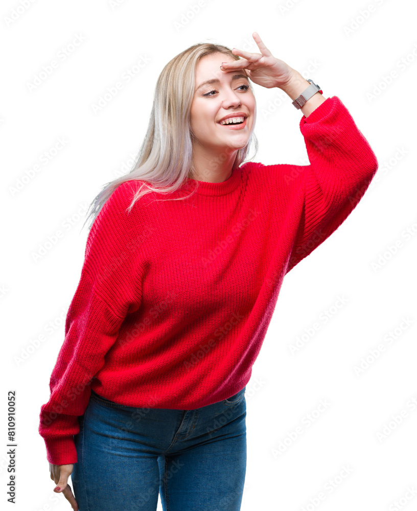 Young blonde woman wearing winter sweater over isolated background very happy and smiling looking far away with hand over head. Searching concept. Young blonde woman wearing winter sweater over isolated background very happy and smiling looking far away with hand over head. Searching concept.