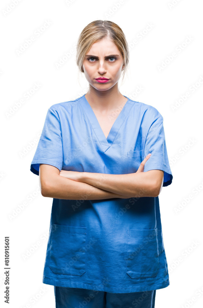 Young beautiful blonde doctor surgeon nurse woman over isolated background skeptic and nervous, disapproving expression on face with crossed arms. Negative person. Young beautiful blonde doctor surgeon nurse woman over isolated background skeptic and nervous, disapproving expression on face with crossed arms. Negative person.