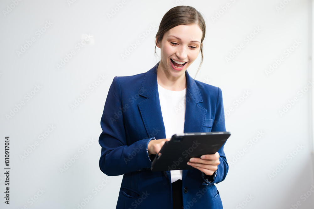 Confident Caucasian businesswoman CEO idea holding tablet and laptop for remote work, online viewing, multitasking isolated Confident Caucasian businesswoman CEO idea holding tablet and laptop for remote work, online viewing, multitasking isolated