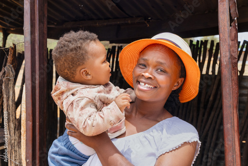 Принти на полотні village african mother and baby standing at the entrance of the shack, township