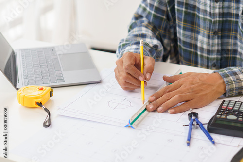 A home architect is reviewing a draft house plan. Projects assigned by customers and customized design before delivery Interior design and decoration ideas, African American, Indian photo