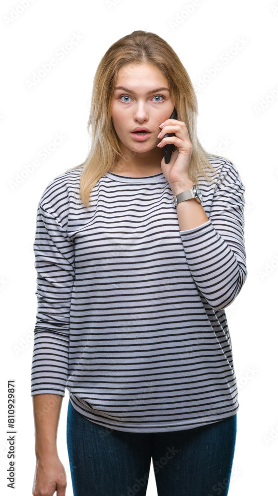 Young caucasian woman showing smartphone screen over isolated background scared in shock with a surprise face, afraid and excited with fear expression Young caucasian woman showing smartphone screen over isolated background scared in shock with a surprise face, afraid and excited with fear expression