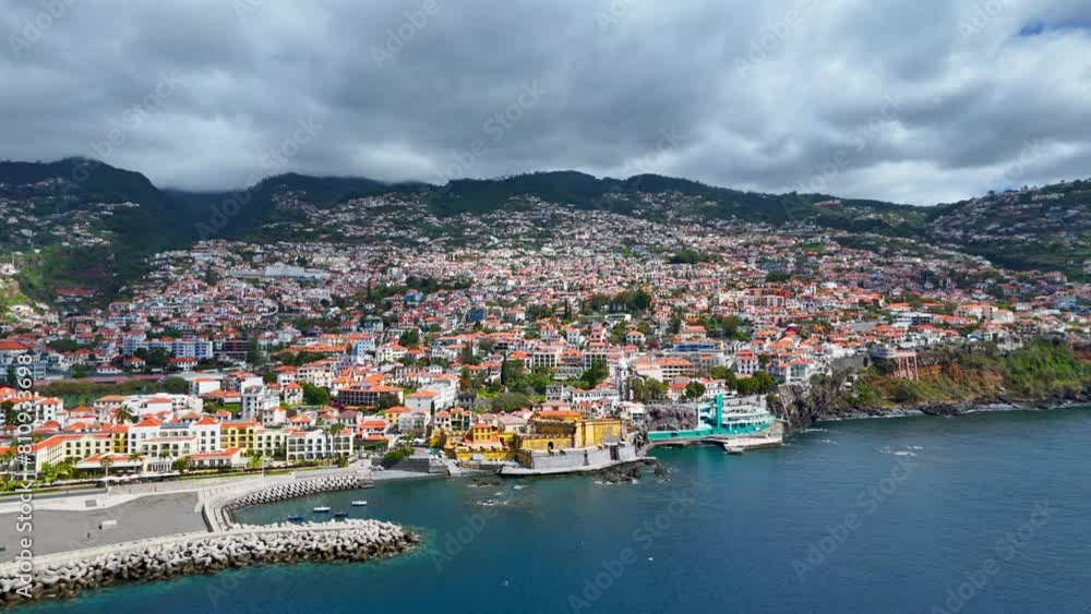 Aerial view of Funchal, Madeira island capital in Portugal. City and mountains in backdrop Aerial view of Funchal, Madeira island capital in Portugal. City and mountains in backdrop