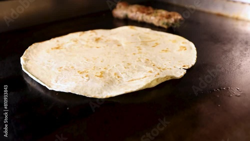 Flatbread cooked on hotplate grill slow motion