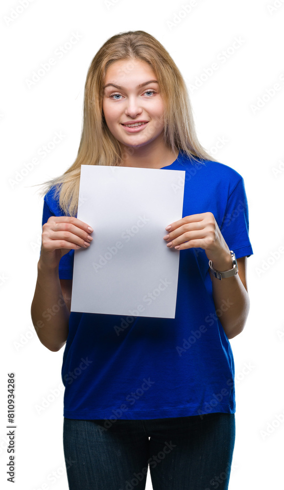 Young caucasian woman holding blank paper sheet over isolated background with a happy face standing and smiling with a confident smile showing teeth Young caucasian woman holding blank paper sheet over isolated background with a happy face standing and smiling with a confident smile showing teeth