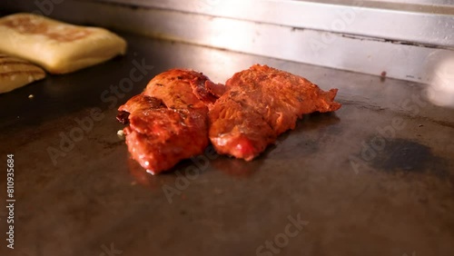 Chicken Tikka closeup cooked on hot plate grill
