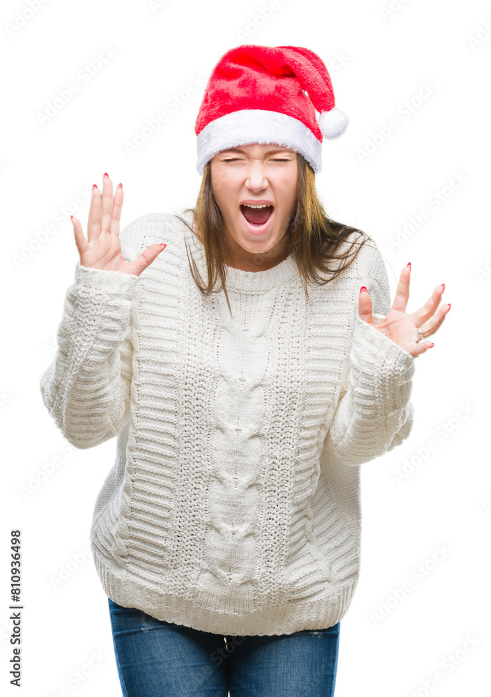 Young beautiful caucasian woman wearing christmas hat over isolated background celebrating mad and crazy for success with arms raised and closed eyes screaming excited. Winner concept Young beautiful caucasian woman wearing christmas hat over isolated background celebrating mad and crazy for success with arms raised and closed eyes screaming excited. Winner concept