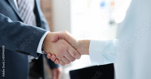Closeup of business partners shaking hands in office 4k movie slow motion. Successful business deal concept