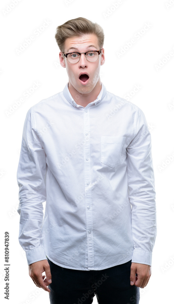 Young handsome blond man afraid and shocked with surprise expression, fear and excited face. Young handsome blond man afraid and shocked with surprise expression, fear and excited face.