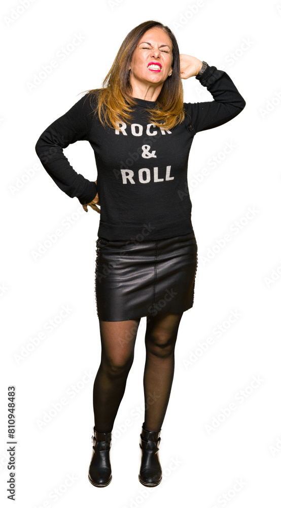Beautiful middle age woman wearing rock and roll sweater stretching back, tired and relaxed, sleepy and yawning for early morning Beautiful middle age woman wearing rock and roll sweater stretching back, tired and relaxed, sleepy and yawning for early morning