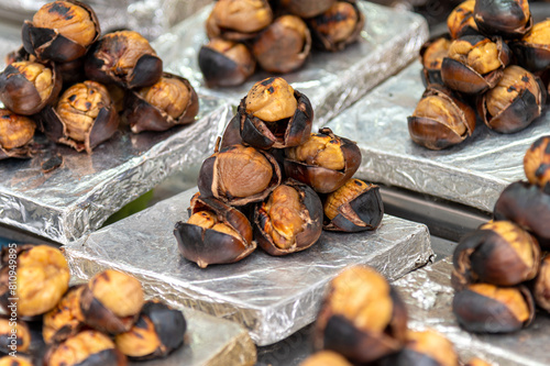 Street food roasted chestnuts. Roasted chestnuts for sale