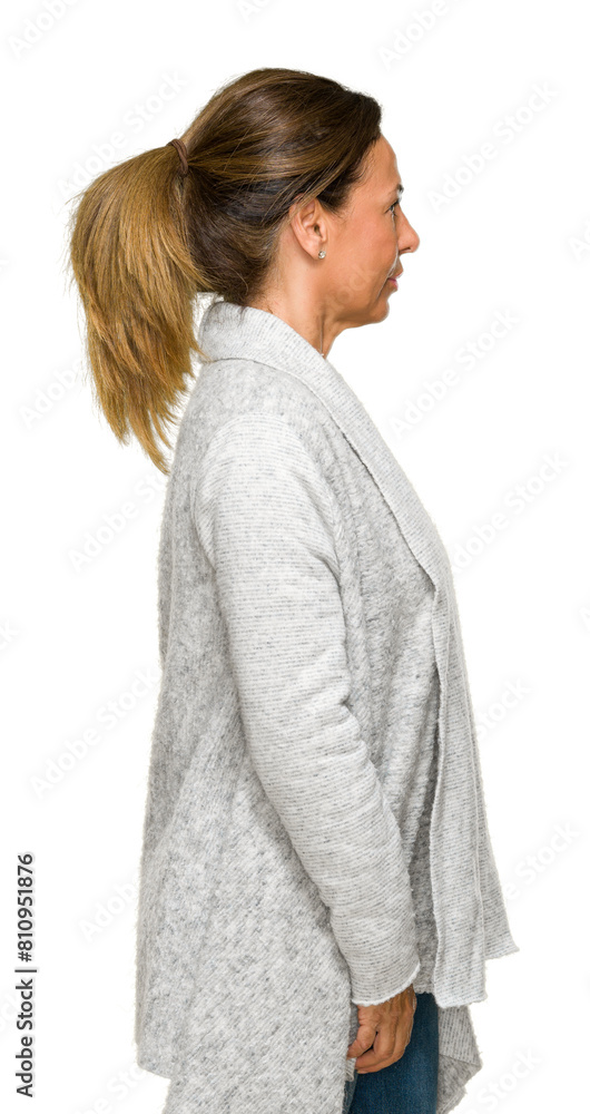Beautiful middle age adult woman wearing winter sweater over isolated background looking to side, relax profile pose with natural face with confident smile. Beautiful middle age adult woman wearing winter sweater over isolated background looking to side, relax profile pose with natural face with confident smile.