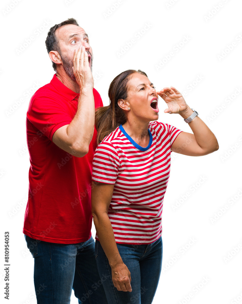 Middle age hispanic couple in love over isolated background shouting and screaming loud to side with hand on mouth. Communication concept. Middle age hispanic couple in love over isolated background shouting and screaming loud to side with hand on mouth. Communication concept.