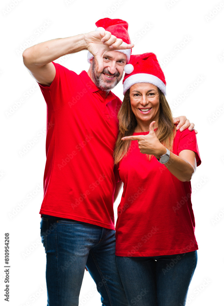 Middle age hispanic couple wearing christmas hat over isolated background smiling making frame with hands and fingers with happy face. Creativity and photography concept. Middle age hispanic couple wearing christmas hat over isolated background smiling making frame with hands and fingers with happy face. Creativity and photography concept.