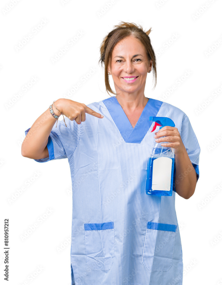 Middle age brunette cleaner woman wearing housework uniform over isolated background with surprise face pointing finger to himself Middle age brunette cleaner woman wearing housework uniform over isolated background with surprise face pointing finger to himself