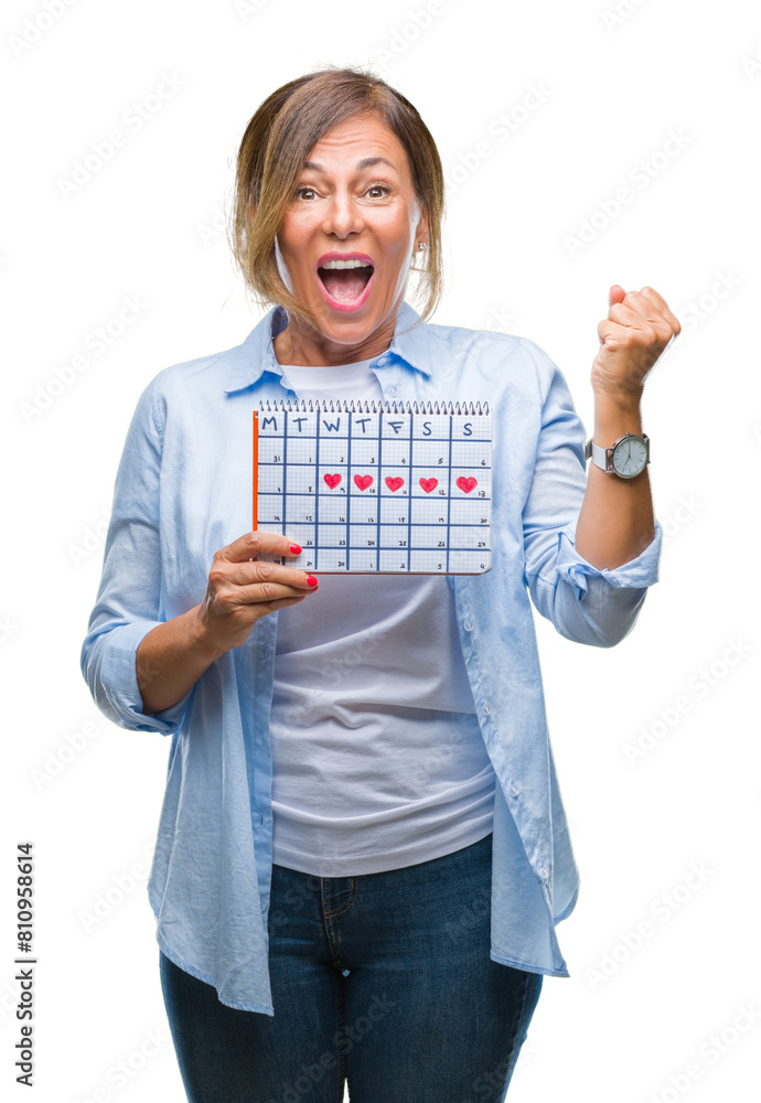 Obraz premium Middle age senior hispanic woman holding menstruation calendar over isolated background screaming proud and celebrating victory and success very excited, cheering emotion