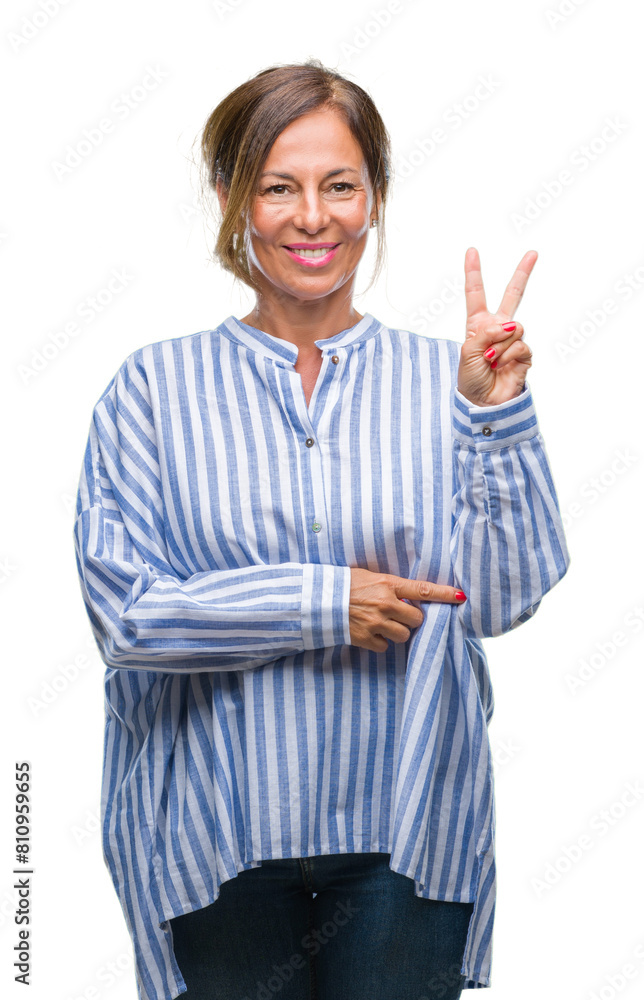 Middle age senior hispanic woman over isolated background smiling with happy face winking at the camera doing victory sign. Number two. Middle age senior hispanic woman over isolated background smiling with happy face winking at the camera doing victory sign. Number two.