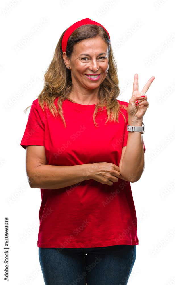 Middle age senior hispanic woman over isolated background smiling with happy face winking at the camera doing victory sign. Number two. Middle age senior hispanic woman over isolated background smiling with happy face winking at the camera doing victory sign. Number two.