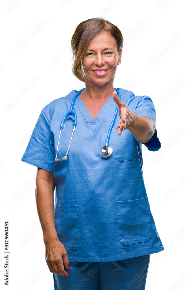 Middle age senior nurse doctor woman over isolated background smiling friendly offering handshake as greeting and welcoming. Successful business. Middle age senior nurse doctor woman over isolated background smiling friendly offering handshake as greeting and welcoming. Successful business.