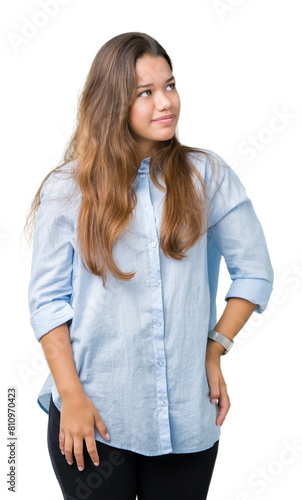 Young beautiful brunette business woman over isolated background looking away to side with smile on face, natural expression. Laughing confident. © Krakenimages.com