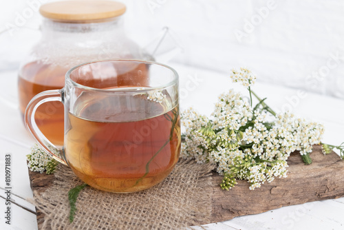 tea in a teapot (decoction)from the leaves and flowers of medicinal yarrow (Achillea) in a cup. Traditional medicine, the collection of useful herbs. Alternative medicine