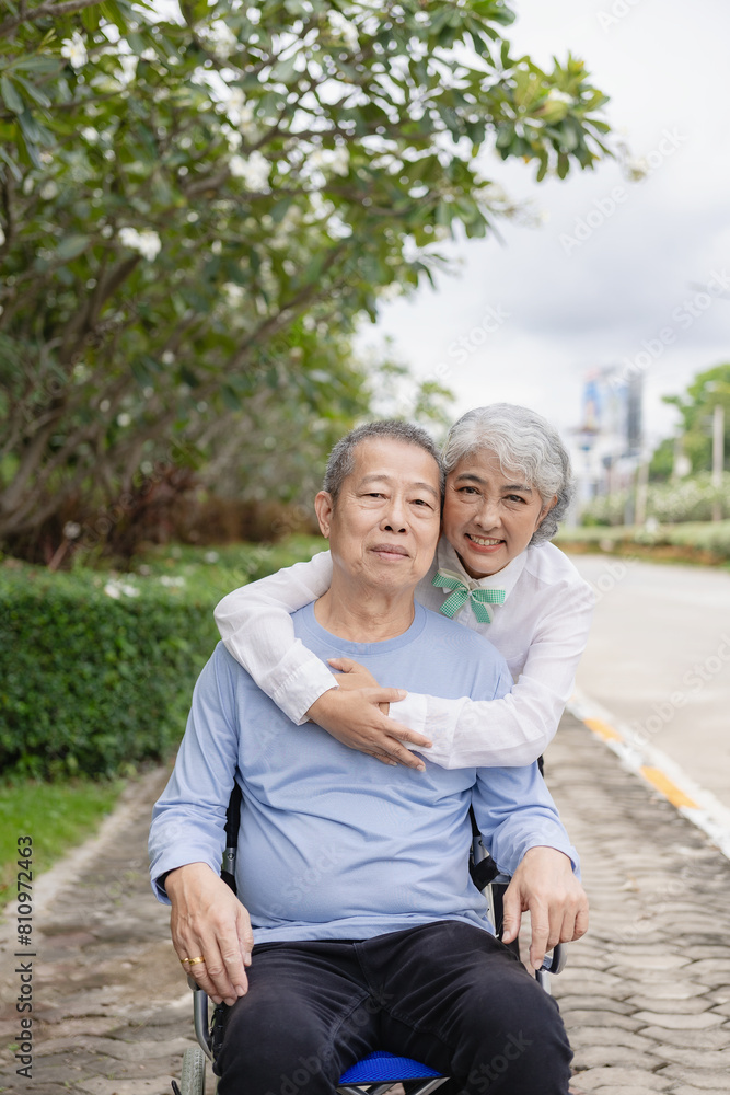 Happy Asian senior couple walking together on a tropical forest path Retired old man and woman having fun and enjoying outdoor travel activities. Vertical image Happy Asian senior couple walking together on a tropical forest path Retired old man and woman having fun and enjoying outdoor travel activities. Vertical image