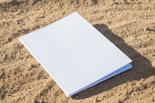 blank magazine mockup on sandy beach photo